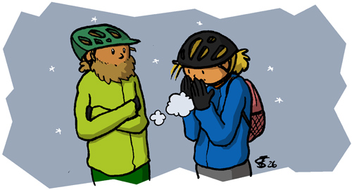 Justus und Juja in Winterfahrradkleidung, umgeben von kleinen Eiskristallen. Juja pustet ihre Hände warm